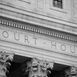 Marble courthouse building facade in black and white.