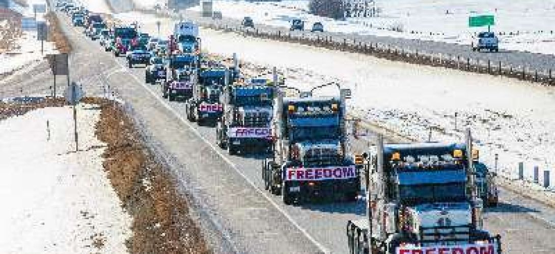 Convoy of big rig trucks in the snow